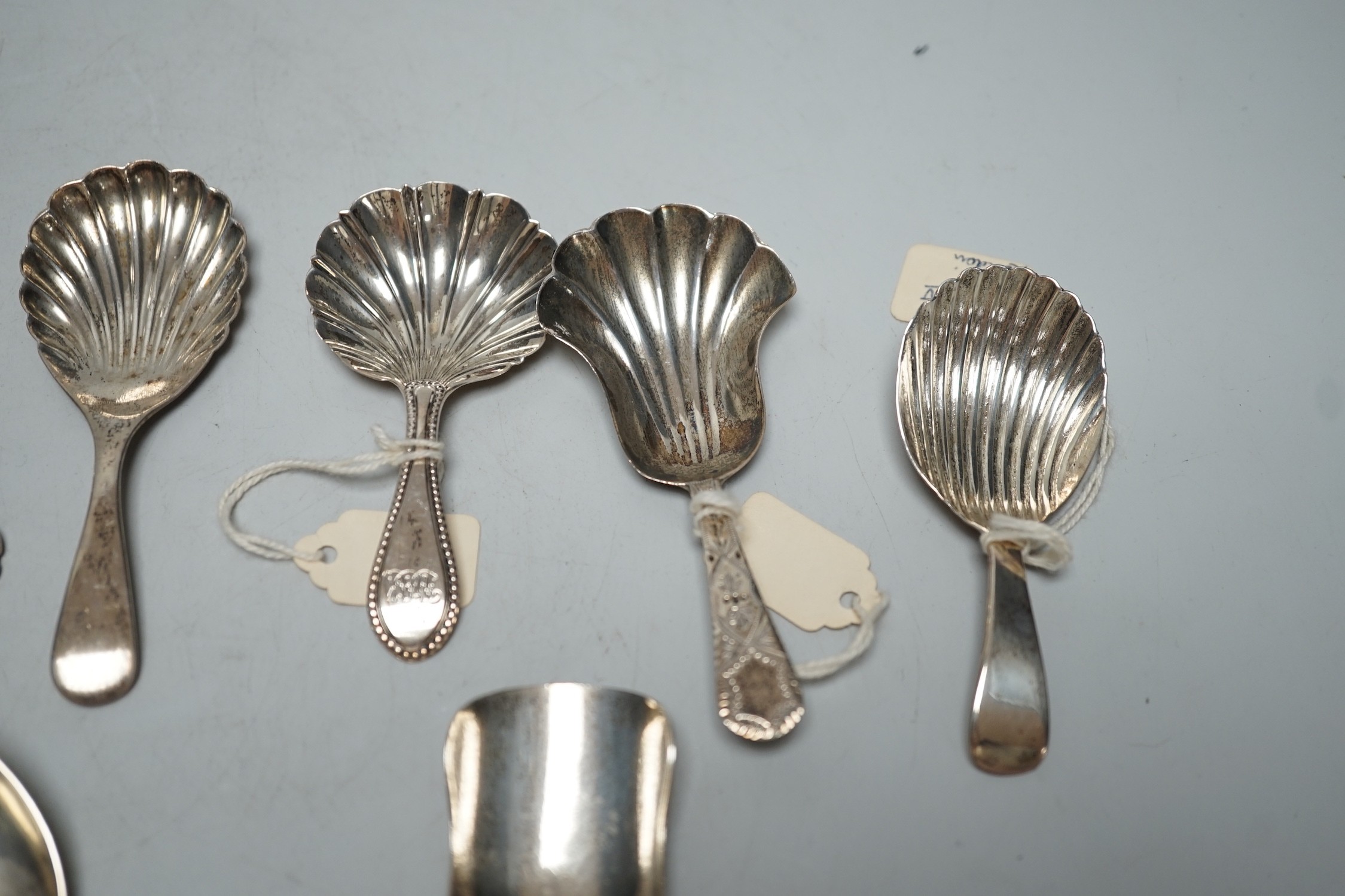 Three assorted 19th century silver caddy spoons, including London, 1829, three 20th century silver caddy spoons and two other silver spoons including Victorian sifter spoon, 14.7cm.